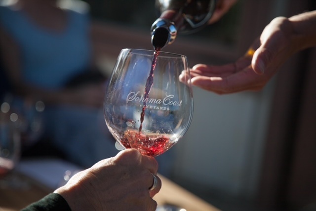 Picture shows red wine being poured into a glass.