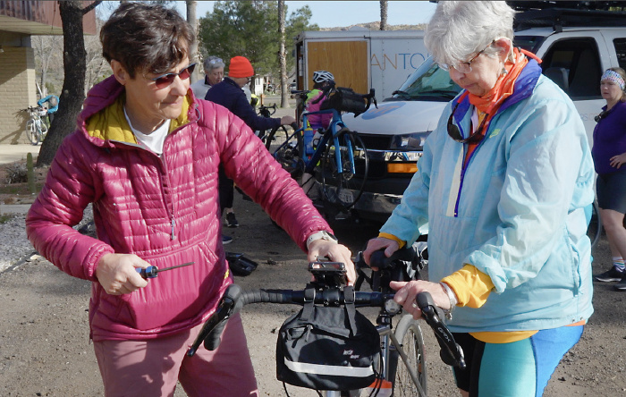 Two women preparing to go on a WomanTours bike tour vacation