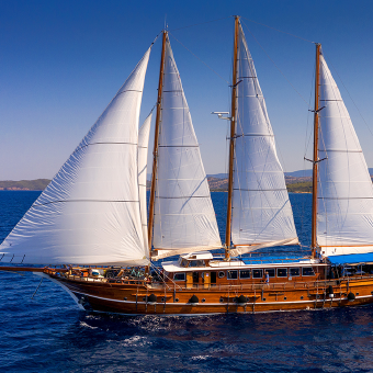 Thalassa boat with sails up on Greece bike and boat tour