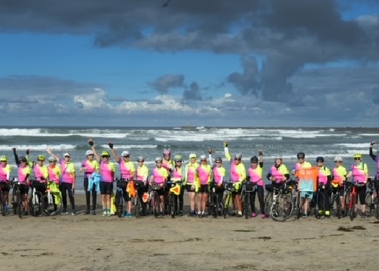 Two dozen women and their bicycles line up in front of the Pacific Ocean in San Diego before departing on a cross-country bike tour to St. Augustine on a Southern Tier Bike Tour