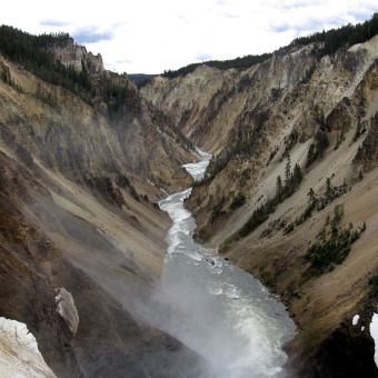 River in between mountains Yellowstone and Grand Teton National Parks Bike Tour