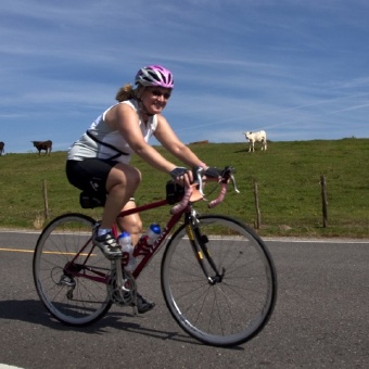 Two cyclist riding along side farm during Louisiana Bike Tour